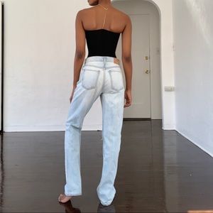 High waisted destressed jeans by Commune.
